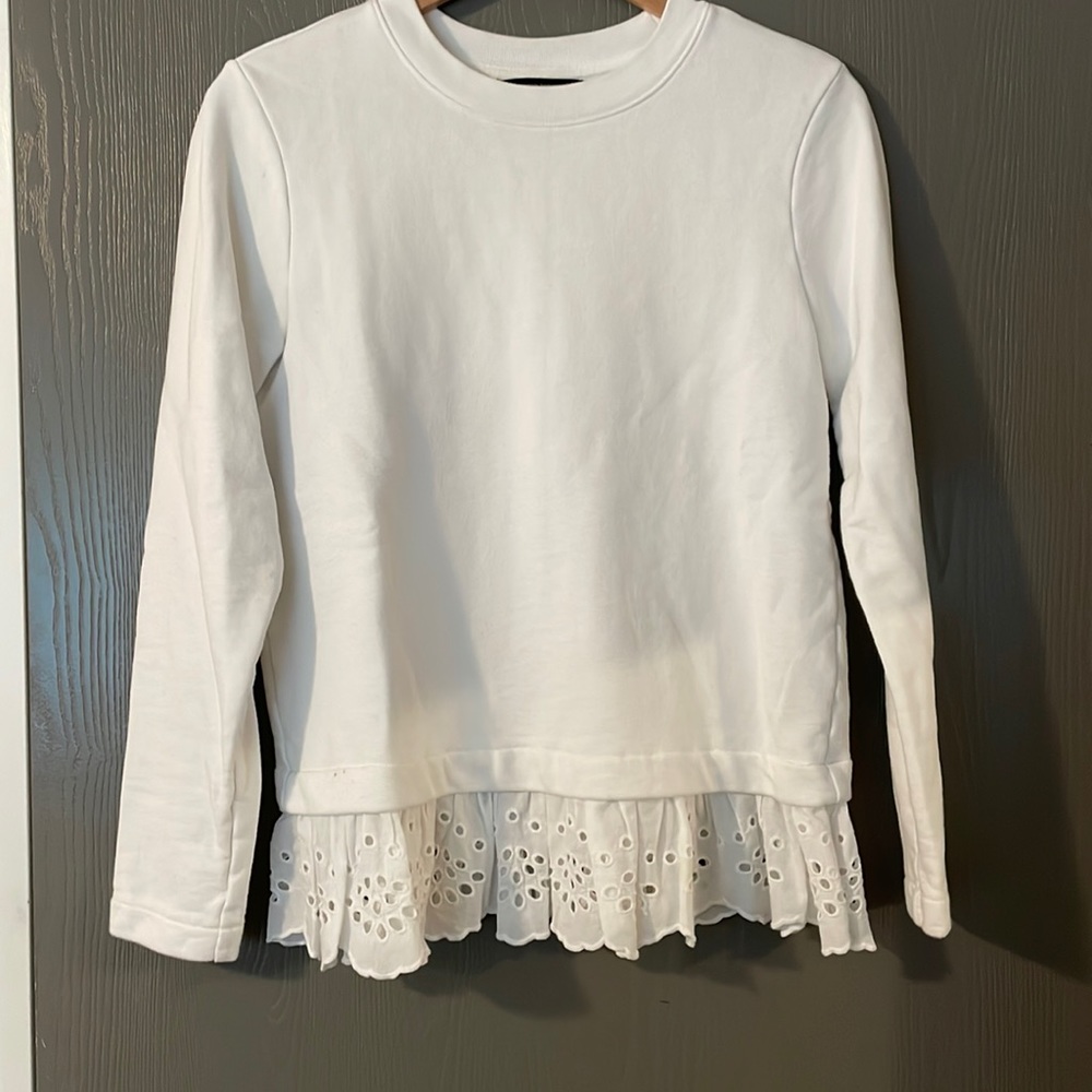 White sweatshirt with ruffle hem